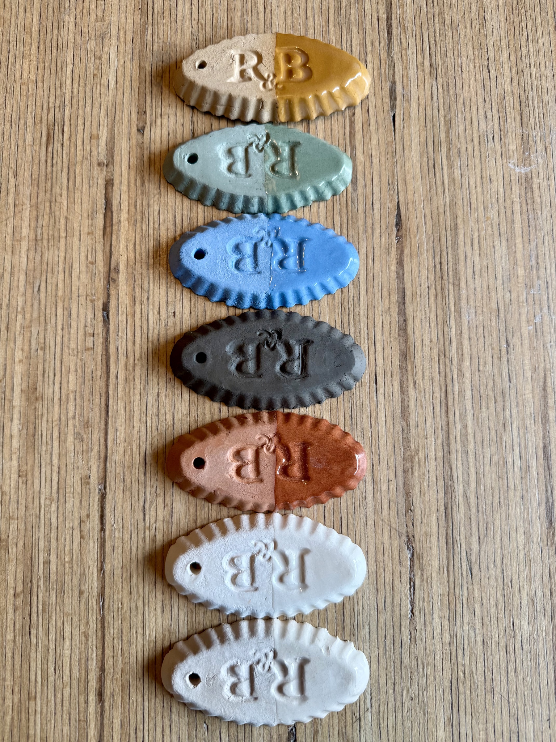 Palette of the seven Beck Earthenware bodies showing each raw and glazed surface