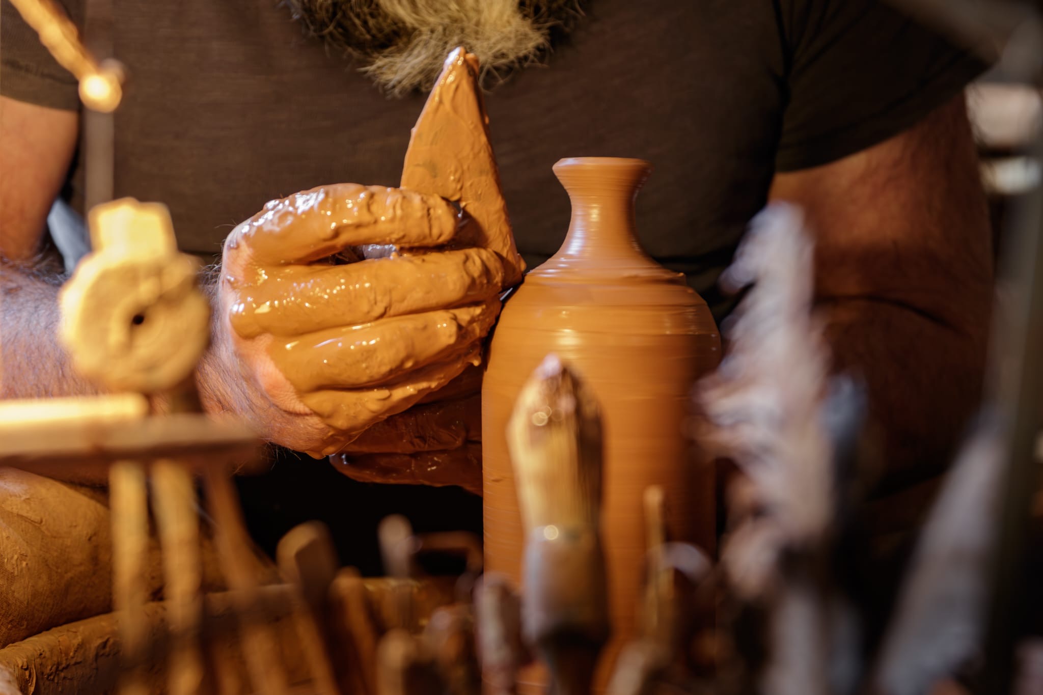 Peter Potter throwing a Noron Stoneware piece in his workshop