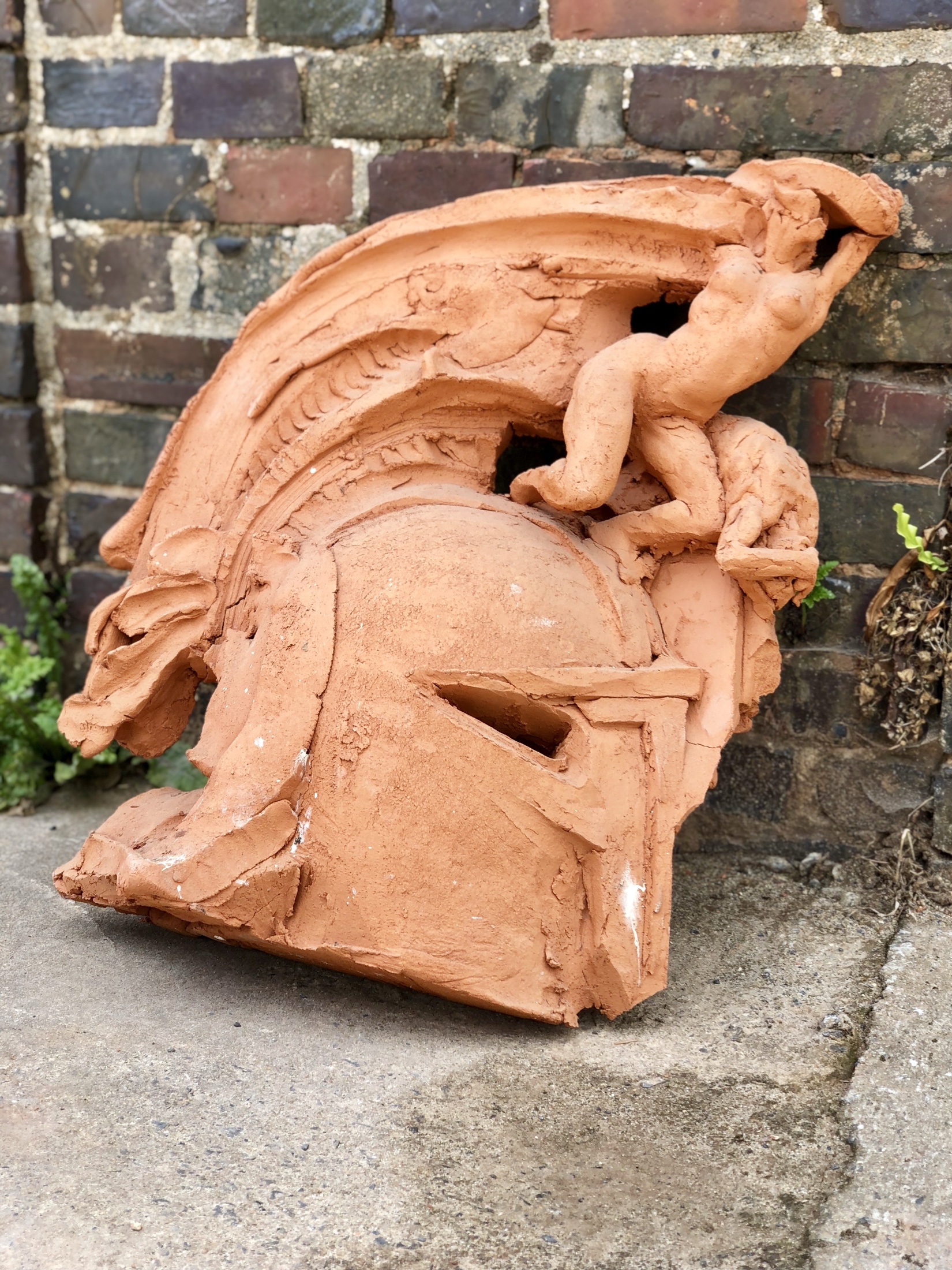 Terracotta sculpture with a figure and modelled face in Noron Stoneware