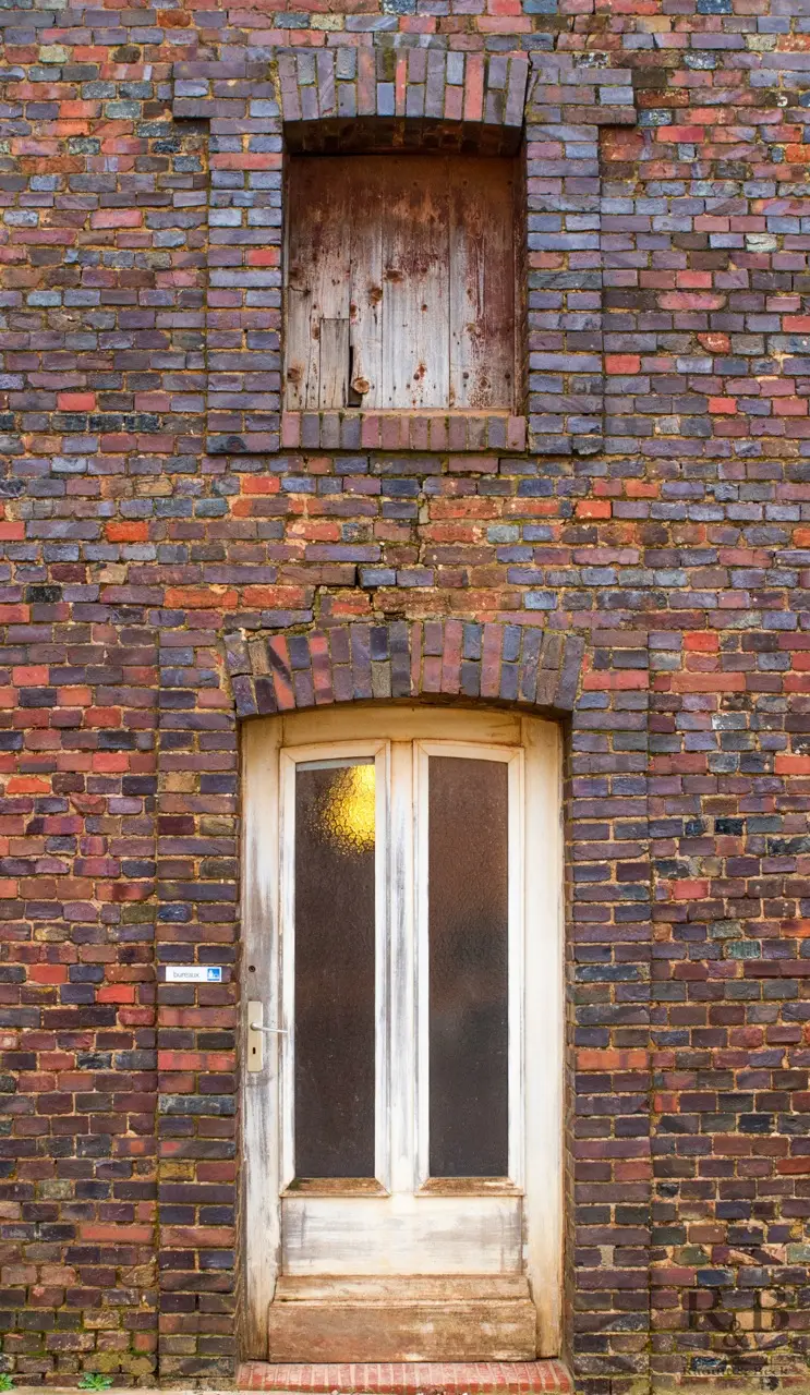 Historic polychrome brick facade of the Saon factory