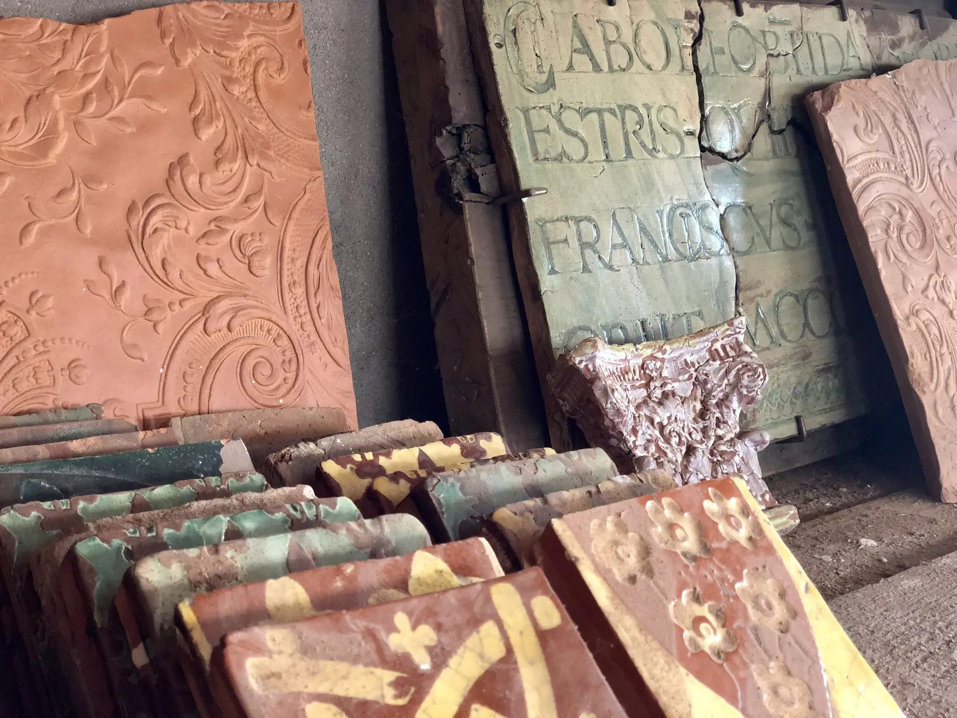 Historic tiles and reliefs kept in the Saon workshop